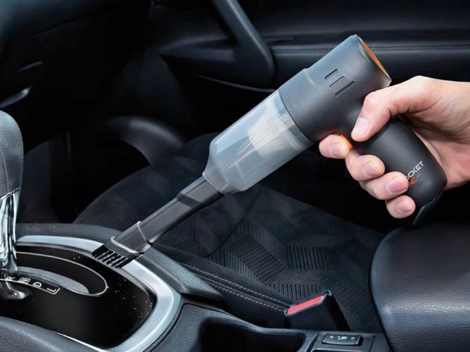 A person holding a Pocket Vac - The 2-in-1 Handheld Vacuum and Blower for Fast and Easy Cleaning Anywhere. 