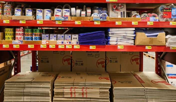 Red Dexion (Shelving) in a Bunnings store with Moving supplies on it.
