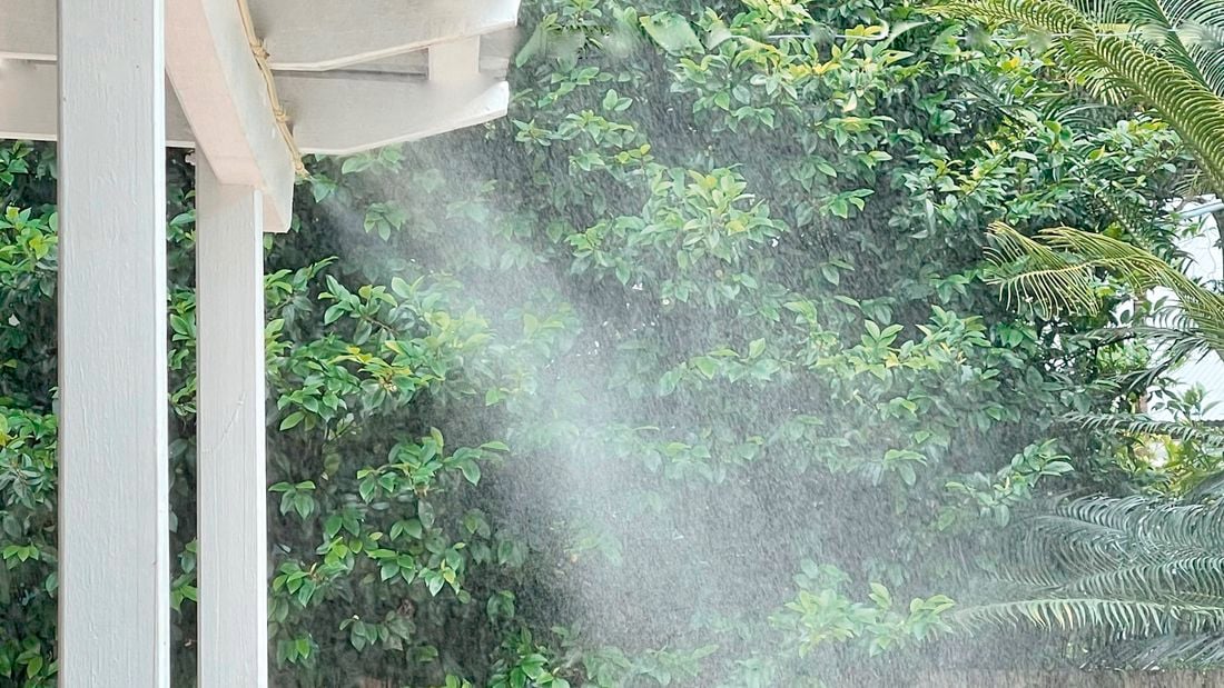 Mist on roof with fence and tree in background