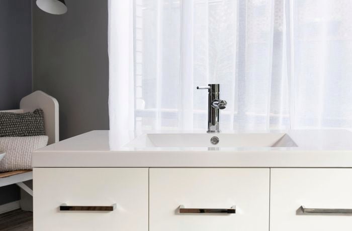Bathroom sink installed on top of a vanity