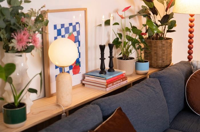 The shelf is styled with a mix of practical and decorative items to make the space feel warm and organised. 