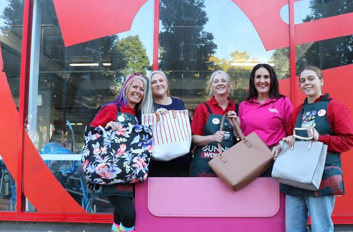 Ladies standing out the front of a Bunnings stores, each one holding onto a large handbag to donation for our Share the dignity fundraisier
