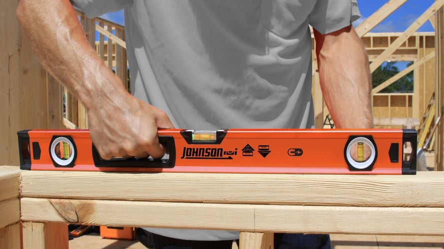 Person using box level to level timber