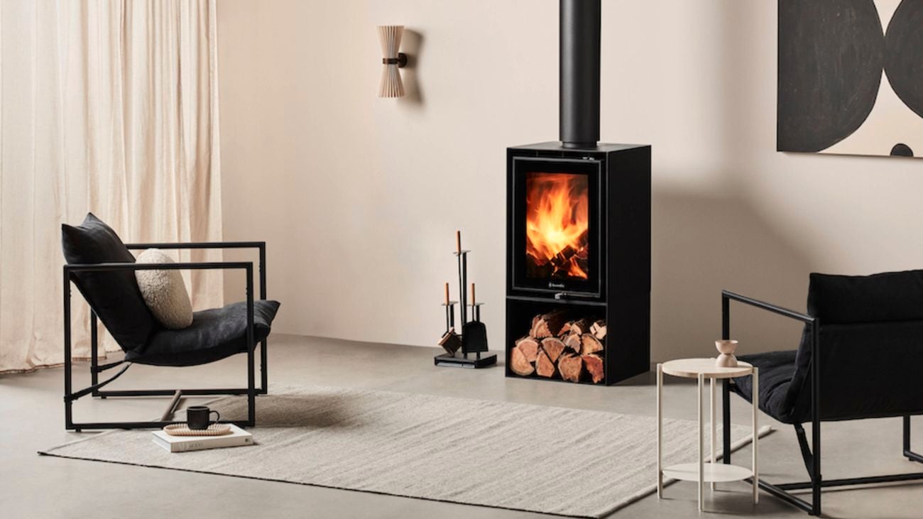 A Fraam Horizon fireplace in a living room with blue walls and timber furnishing