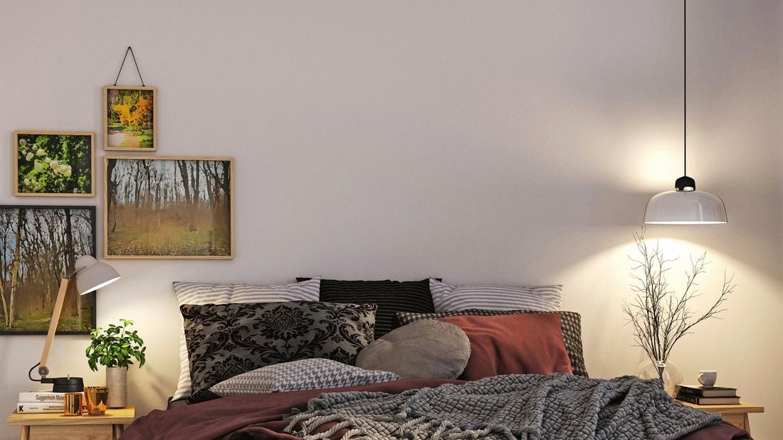 a bedroom with bed and wall art