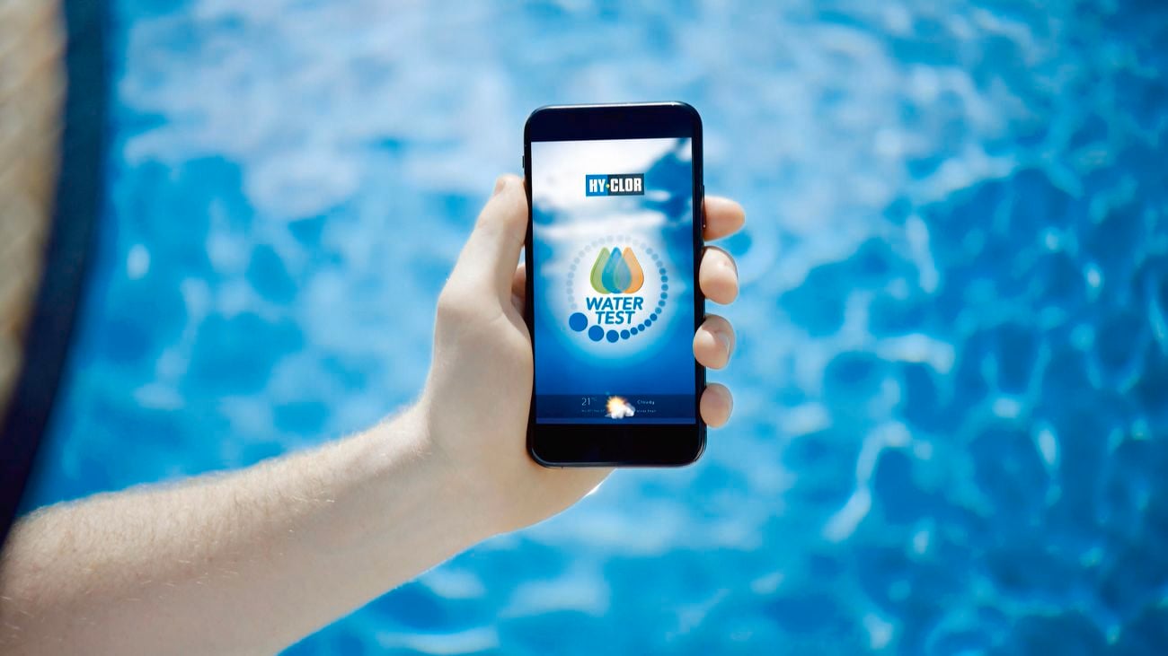 Man holding phone with Hy-Clor water test app