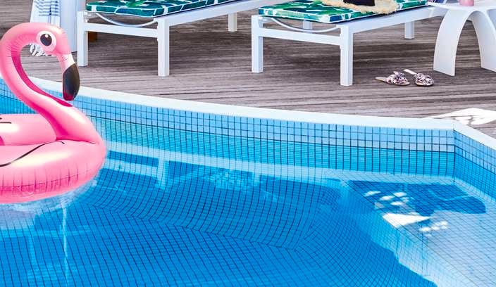 Pool with flamingo floating pool toy and banana lounges