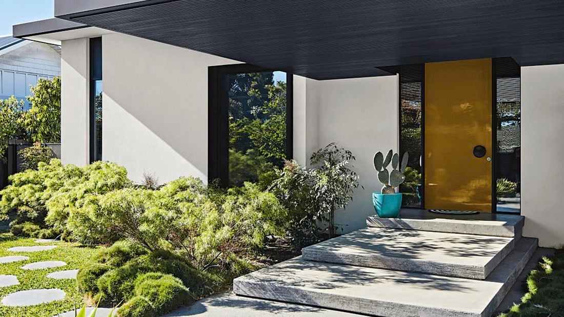 Exterior of modern house with blue sky in the background.
