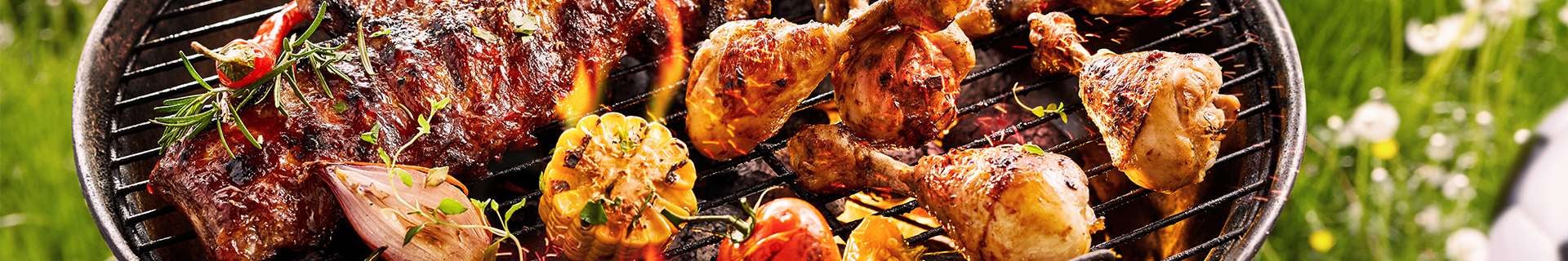 BBQ with food cooking on it.