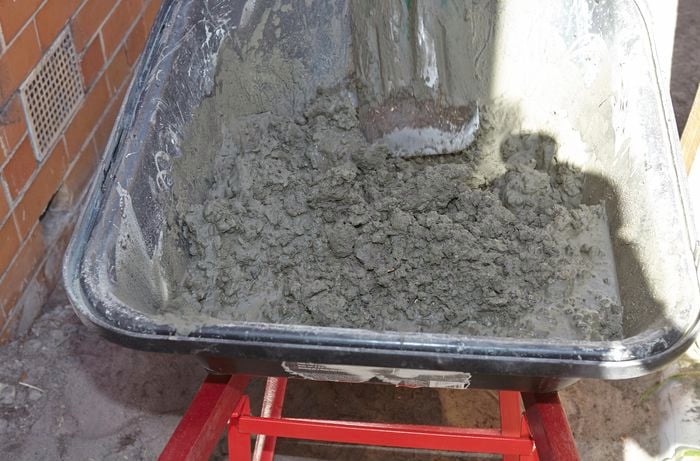 A wheelbarrow containing cement mix