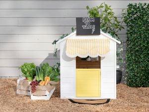 A finished cubby house customised to look like a greengrocer, pictured from the front