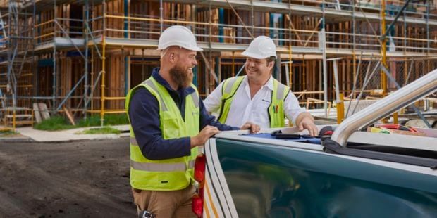 On site builders talking the back of a ute