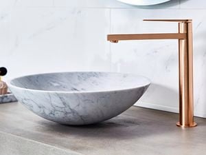 Marble basin with a copper gold tap