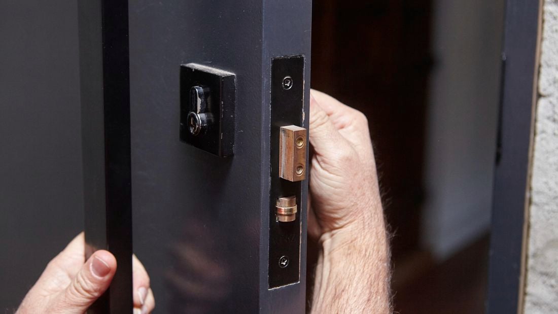 Person fiddling with a door lock.