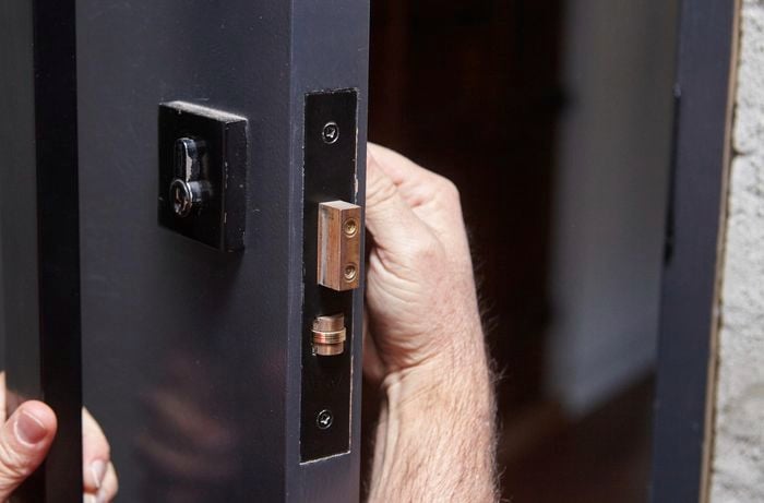 Person fiddling with a door lock.