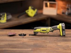 Multi tool on desk with attachments in frame 