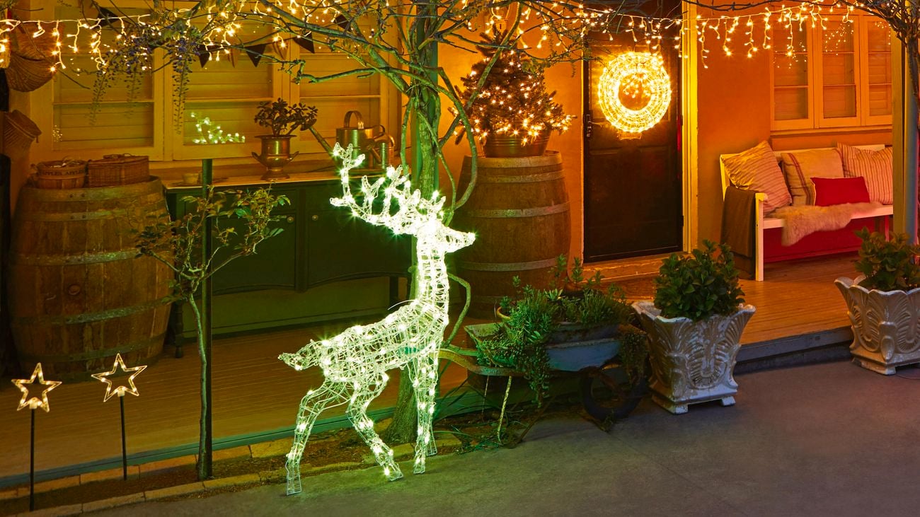 Christmas lights and decorations at the front of an old style house at night