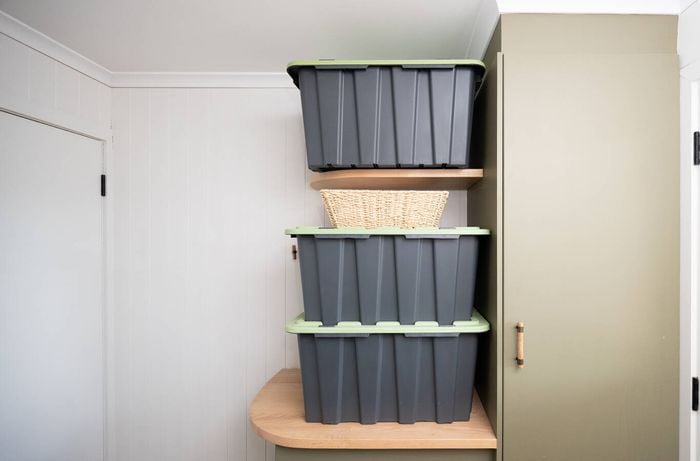 Clear out all kitchen cupboards, drawers and shelves, and box up items with clear labels in neatly stacked storage tubs and a basket before renovation.