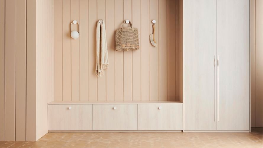 Storage space with a tall double door cabinet, three floor cabinets and accessories hanging on hooks in muted tones. Heritage 150 design.