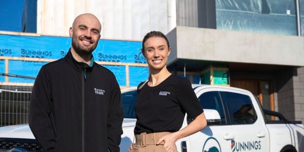 Bunnings trade specialist on a building site, they are standing in front of the Bunnings white ute.