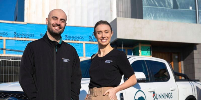 Bunnings trade specialist on a building site, they are standing in front of the Bunnings white ute.