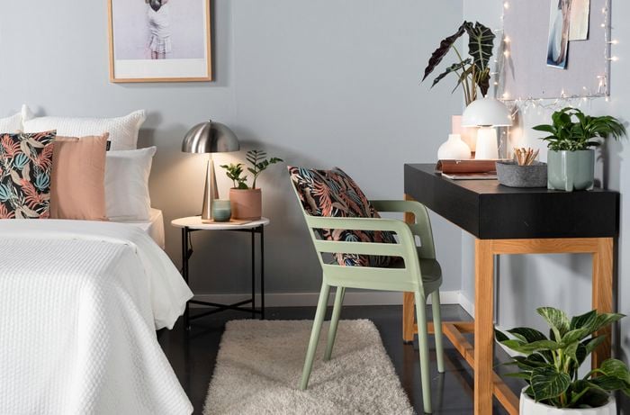 Bedroom with study desk and picture frame hanging 