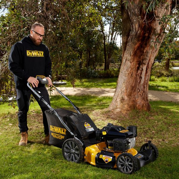 Person using a DEWALT Lawn mower on grass
