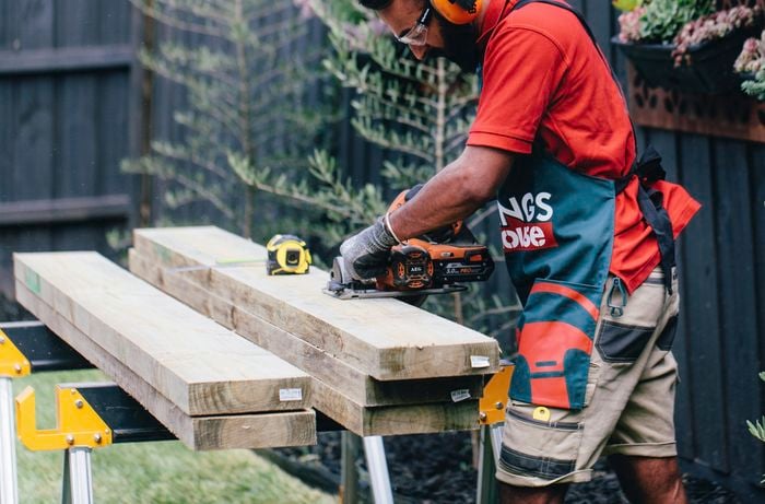 Retaining wall sleepers being cut to size by a Bunnings team member