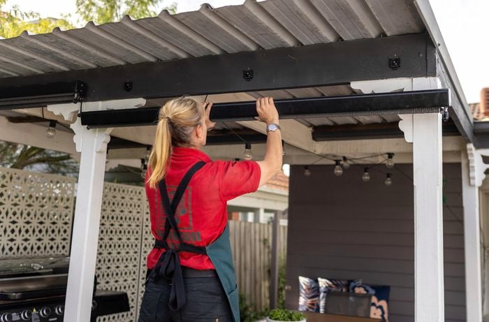 A person installing the pelmet.