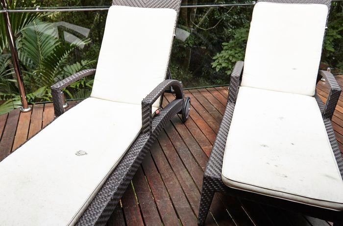 Outdoor lounge chairs with stained cushion covers