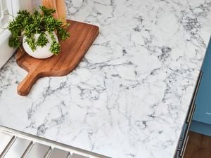 Marble benchtop and wooden chopping board.