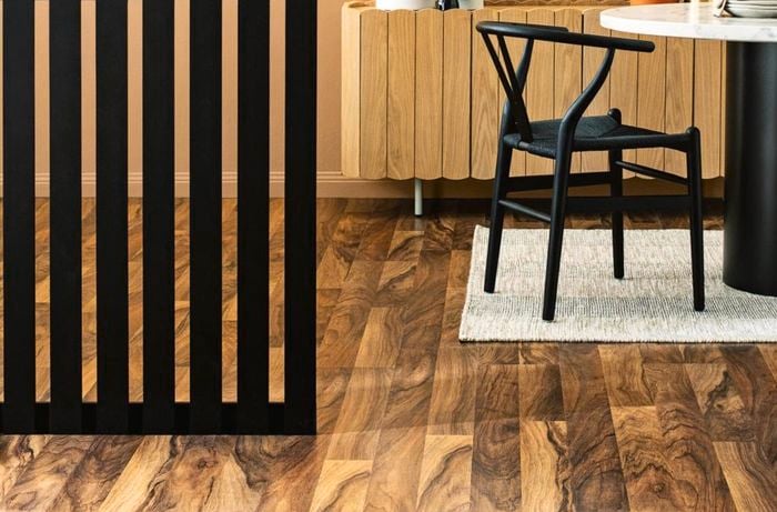 A black painted slatted room divider in a living area