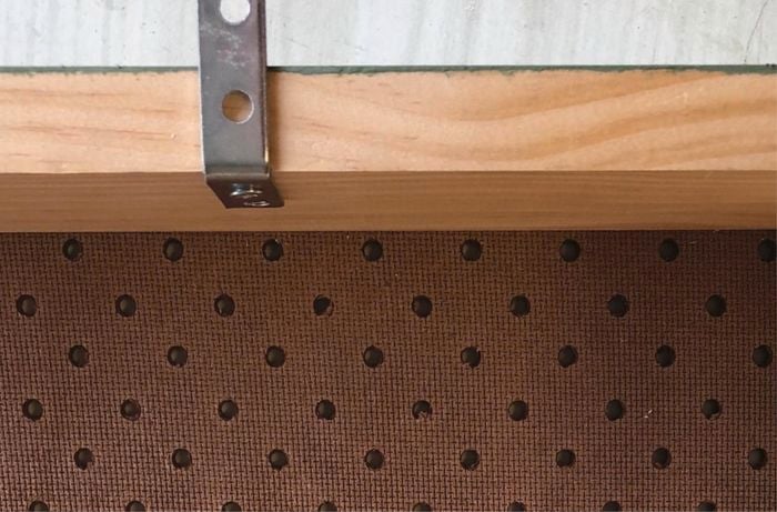 Back of pegboard wall sheet.