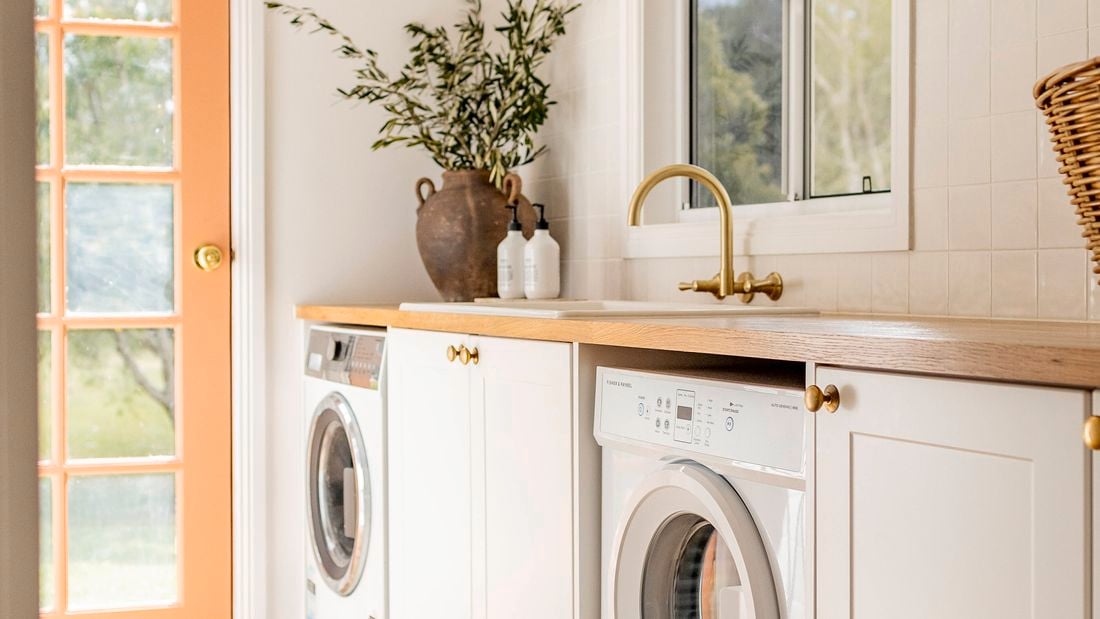 Farmhouse laundry makeover, timber bench tops with washing machine and dryer siting under bench top
