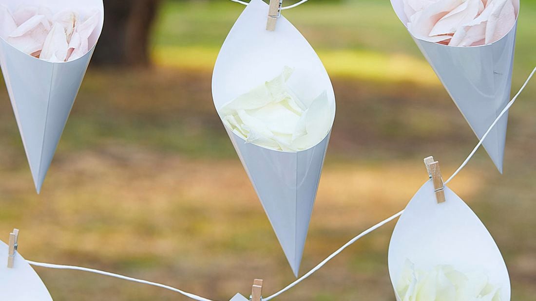 Four decorative cones hang from small pegs filled with rose petals.
