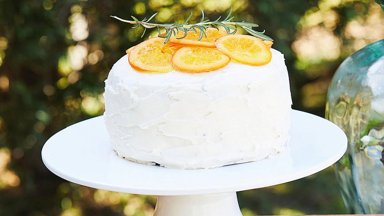 Use two store-bought mud cakes together to make the wedding cake, add some homemade candied orange slices on top and a rosemary sprig to add the finishing touch.
