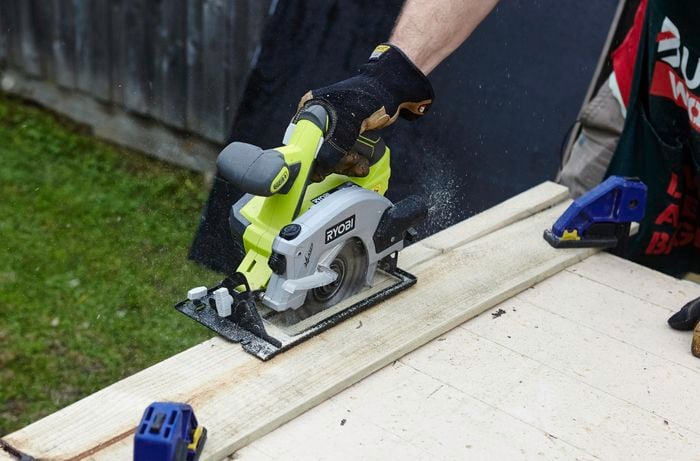 A circular saw being used to cut a plank of timber to size