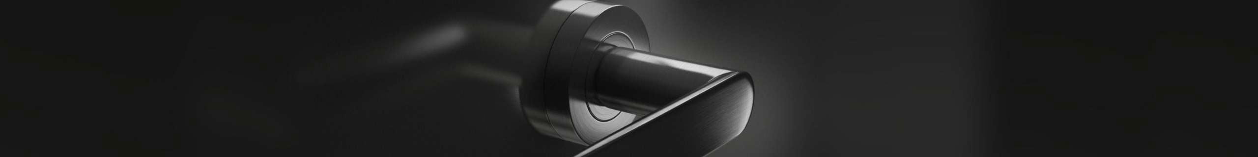 Header image with black door handle being in center of shot