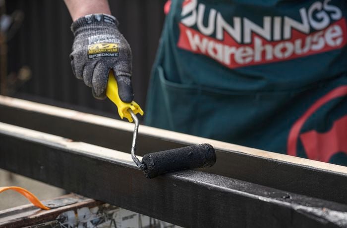 Paint being applied to timber