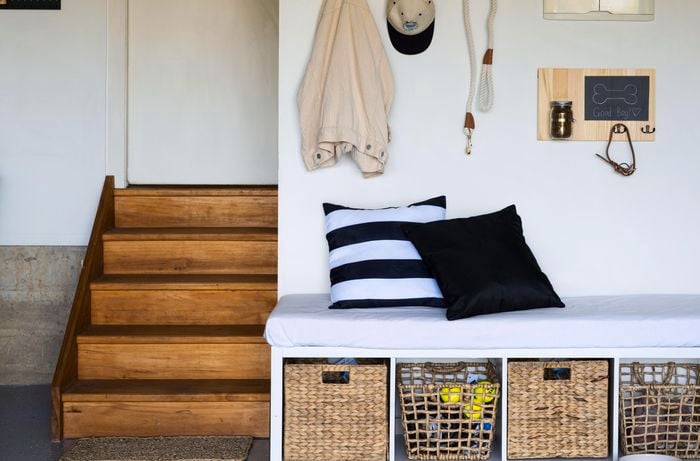 A Clever Cube unit used as a bench seat in a small mud room and pet area in a garage