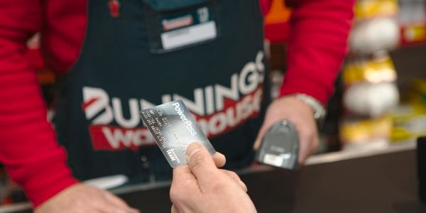 Customer holding PowerPass card at register