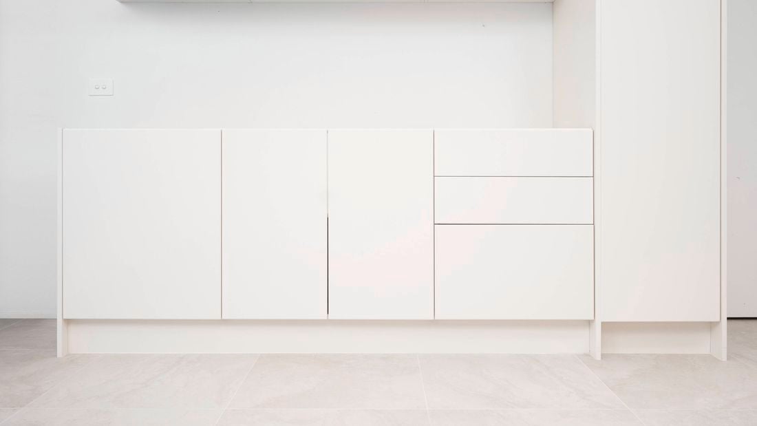  Cabinet with doors, drawers, and a kickboard installed neatly.