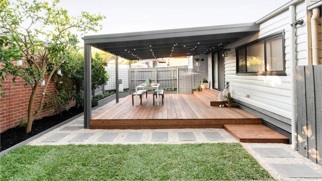 Outdoor deck at the back of a house with outdoor furniture