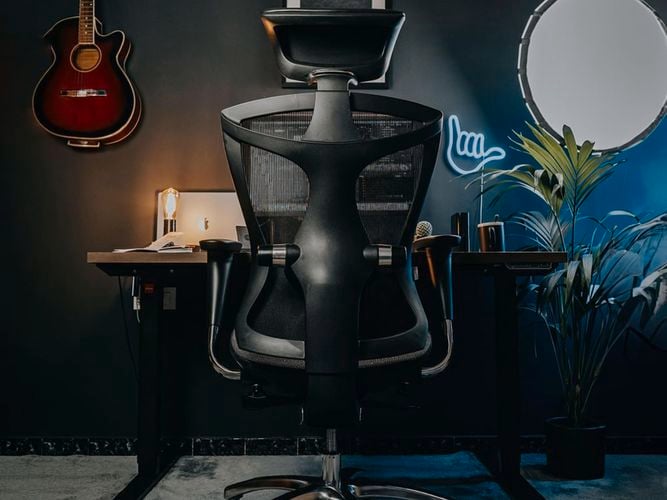 Dark modern room with a SIHOO chair at the computer desk