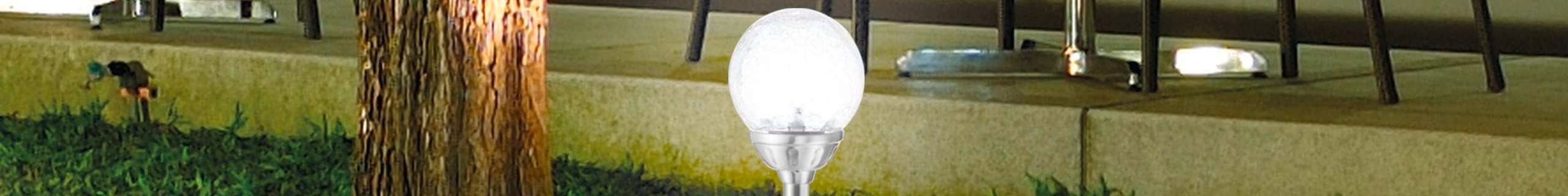 Gardenglo solar garden light in an outdoor dining setting.