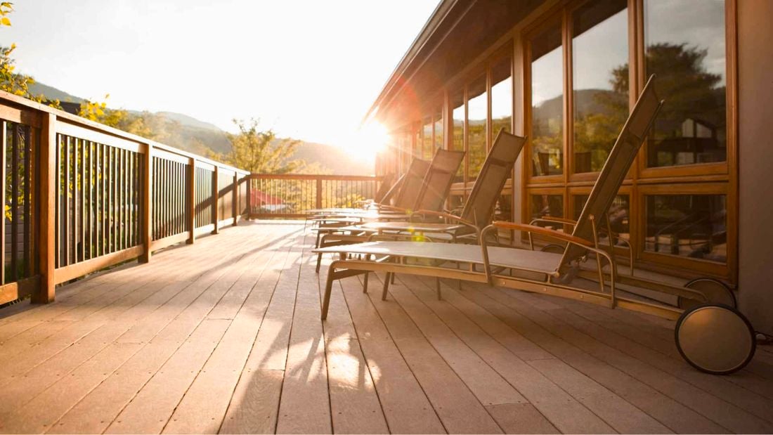 Timber deck at the back of a house with deck chairs