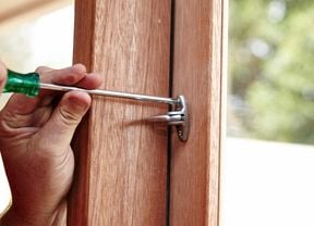 Using a screwdriver to screw the handle in place