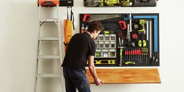 Wall-mounted pegboard, baskets and hooks for power  tools and equipment
