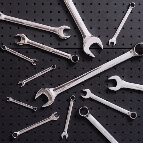 Set of spanners on pegboard background