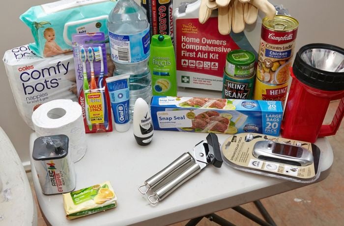 Soap, battery, toilet paper, nappies, baby wipes, toothpaste and brushes, bottled water, garbage bags, a first aid kit, canned food, sealable bags, a solar powered torch and a battery powered torch